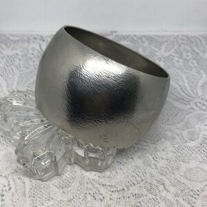 Express silver tone textured wide statement bangle bracelet.